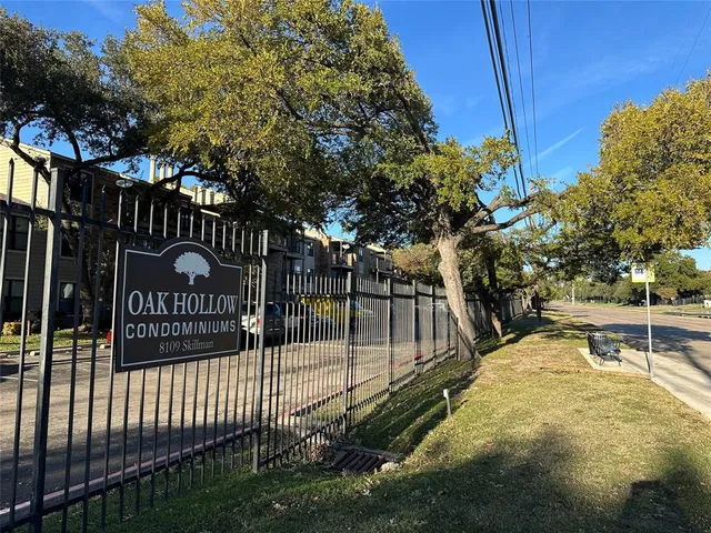 a view of a park with iron fence