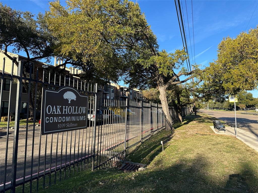 a view of a park with iron fence