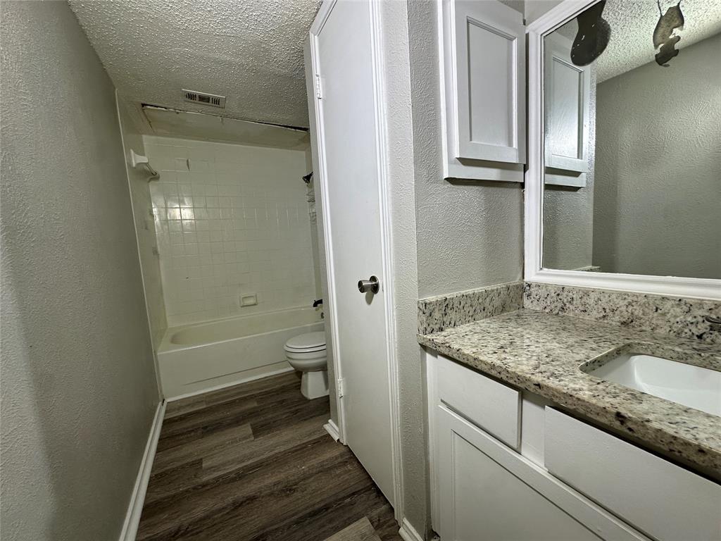 8109 Skillman Street, Unit 2007 Dallas, TX 75231 - Photo 14 of 25 a bathroom with a granite countertop sink toilet and shower