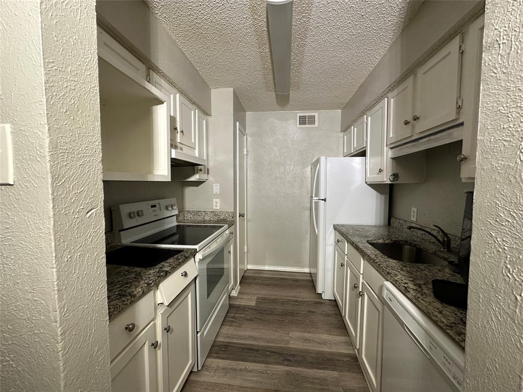 8109 Skillman Street, Unit 2007 Dallas, TX 75231 - Photo 9 of 25 a kitchen with stainless steel appliances granite countertop a stove and a refrigerator
