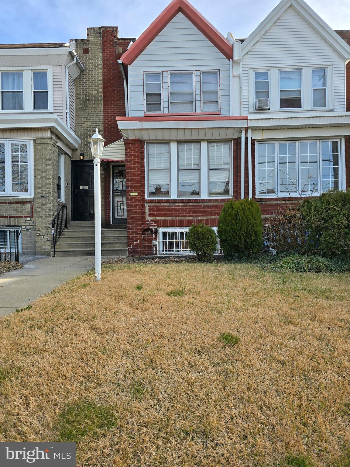 2204 East Washington Lane Philadelphia, PA 19138 - Photo 1 of 31 a view of a brick house with many windows