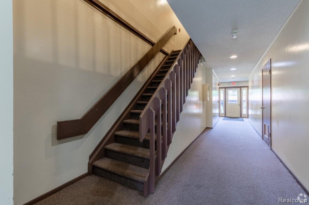 35775 Union Lake Road Clinton Township, MI 48035 - Photo 11 of 30 Staircase featuring carpet flooring and a textured ceiling