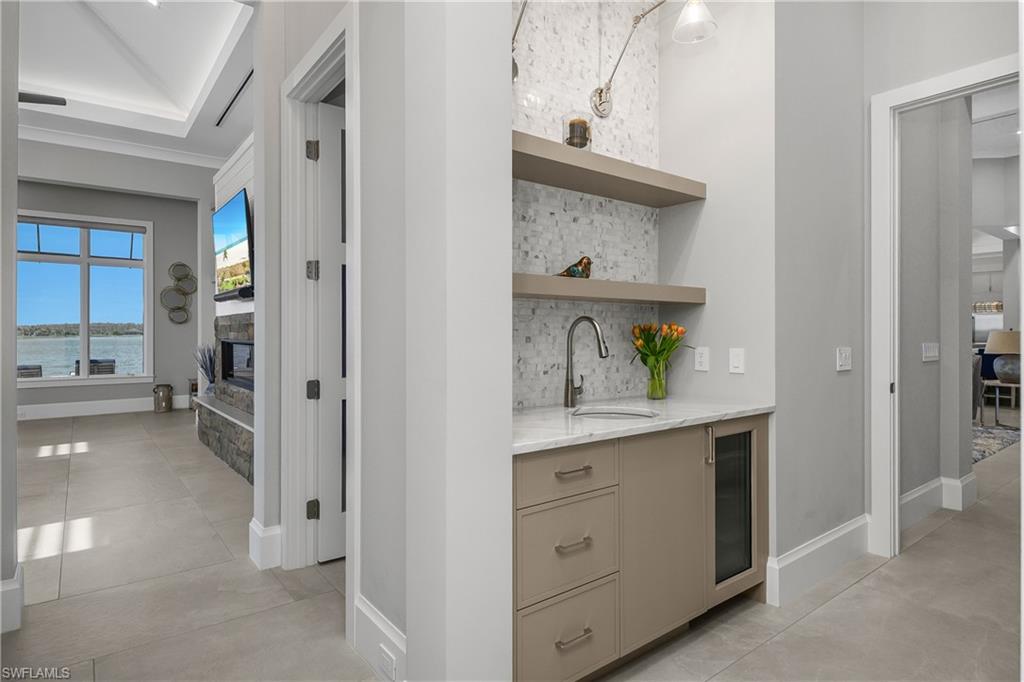 18410 Blue Eye Loop Fort Myers, FL 33913 - Photo 25 of 49 Primary suite includes private coffee bar/beverage service area with U-line under-counter beverage cooler, sink, custom tile and built-in cabinetry.