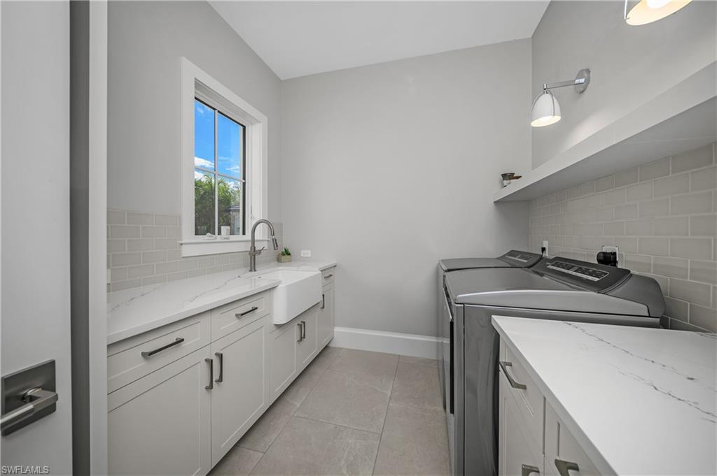 18410 Blue Eye Loop Fort Myers, FL 33913 - Photo 35 of 49 Oversized laundry room with sconce lighting, utility sink, and pull out floor to ceiling drying racks.