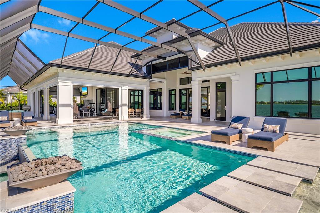 18410 Blue Eye Loop Fort Myers, FL 33913 - Photo 43 of 49 Inground pool/spa covers 520 sq. ft. and is surrounded by travertine pool decking.