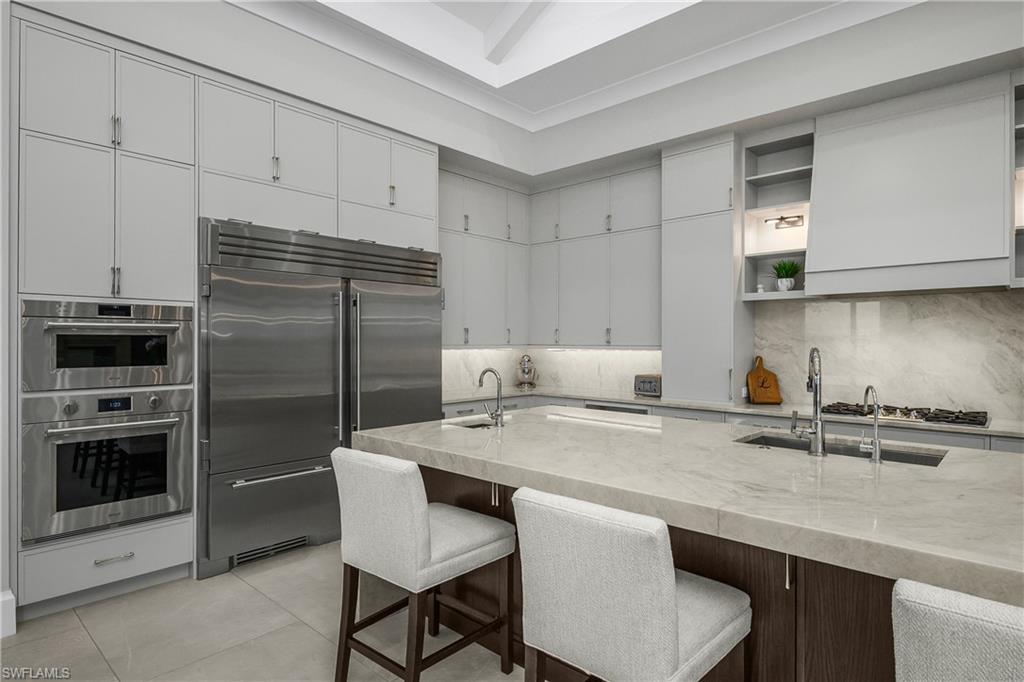 18410 Blue Eye Loop Fort Myers, FL 33913 - Photo 9 of 49 Gourmet kitchen with dual True professional grade refrigerator/freezer units, Blue Star professional grade gas range, dual ovens, cathedral ceilings and custom designer lighting.
