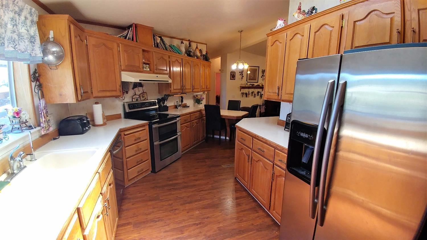 5390 Lower River Road Grants Pass, OR 97526 - Photo 31 of 35 a kitchen with stainless steel appliances granite countertop a refrigerator a stove top oven a sink and dishwasher