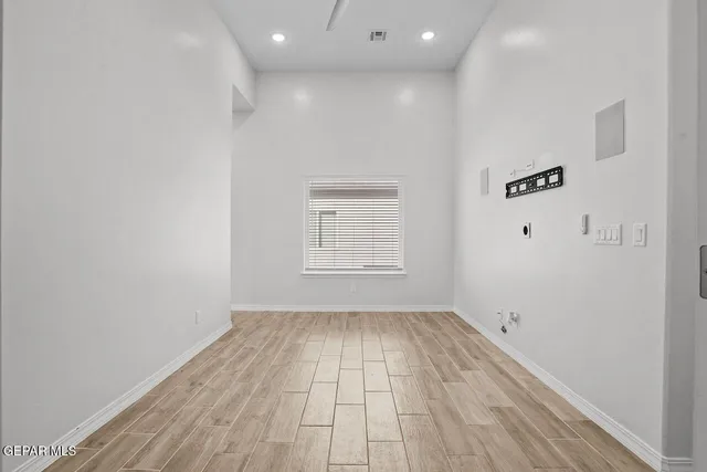 wooden floor in a hall with a window