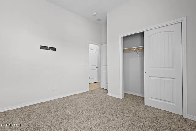a view of an empty room and closet area