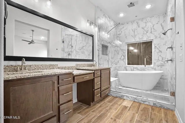 a bathroom with a sink a bathtub and a mirror
