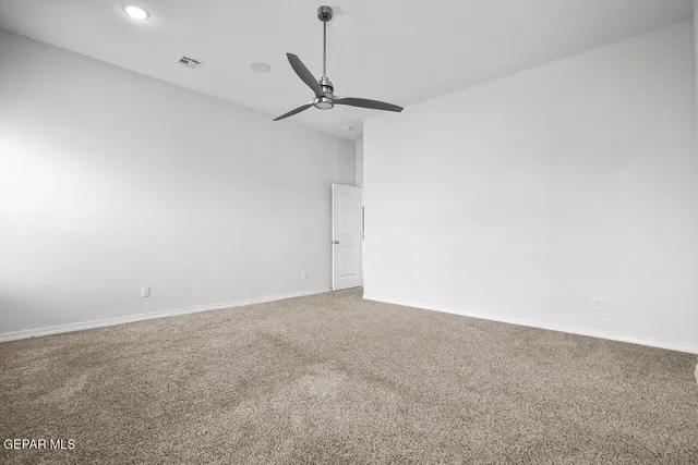 an empty room with a fireplace and window