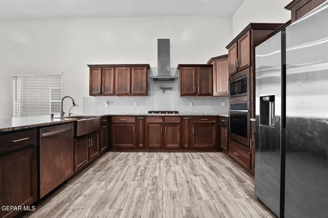 a kitchen with stainless steel appliances a sink and a refrigerator