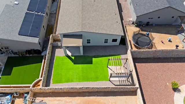 an aerial view of a house with a yard