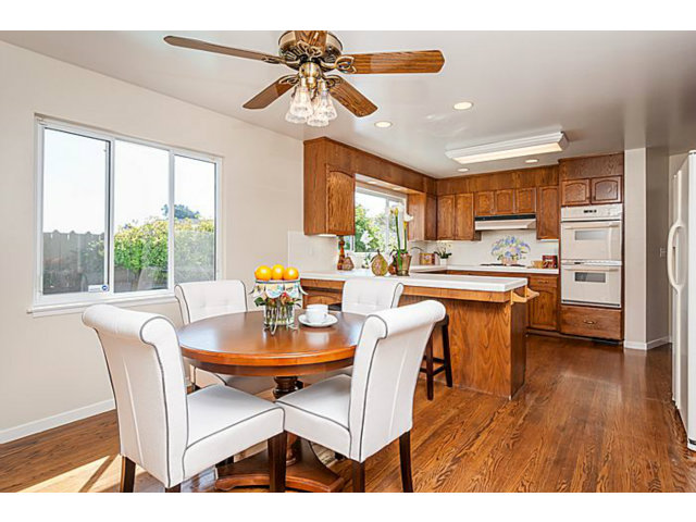 2 Rio Court Burlingame, CA 94010 - Photo 9 of 25 a dining room with stainless steel appliances kitchen island granite countertop a table chairs and a refrigerator