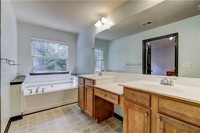 a bathroom with a sink double vanity and a mirror