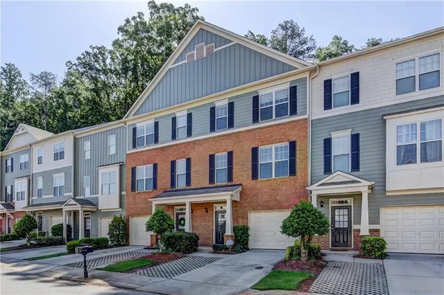 a front view of a residential apartment building with a yard