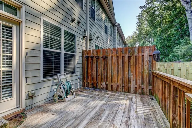 a view of a backyard with a trees and wooden fence