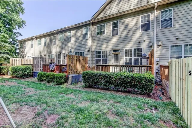 a view of a house with pool and sitting area