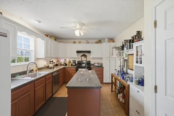 a kitchen with refrigerator a sink and cabinets