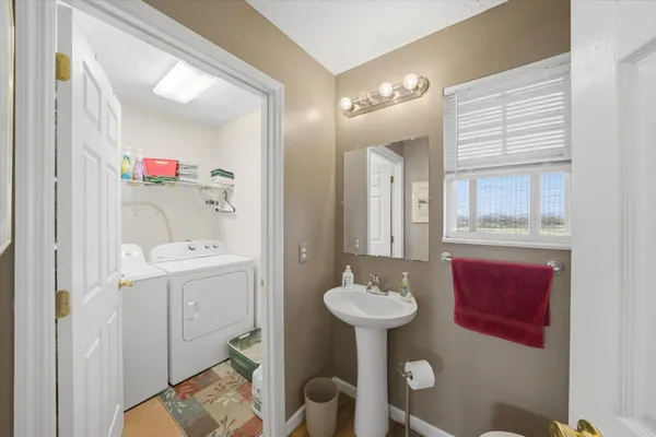 a bathroom with a sink toilet and mirror