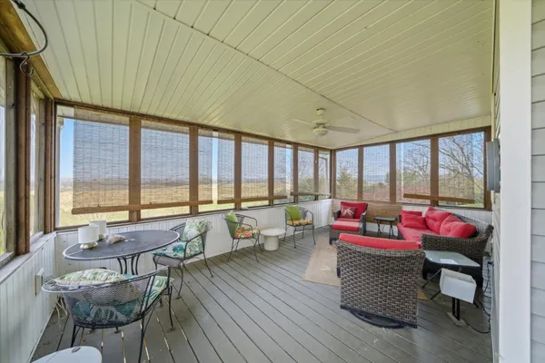 a living room with furniture and a floor to ceiling window