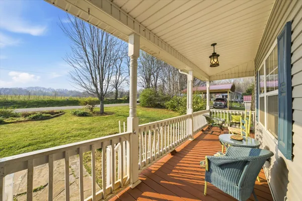 a view of balcony with wooden floor and fence