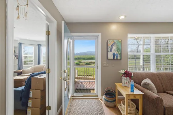a living room with furniture and a floor to ceiling window