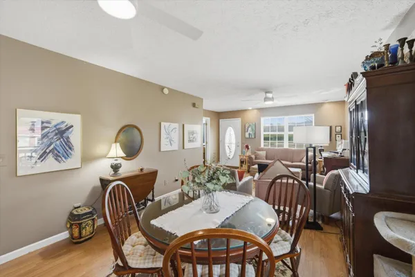 a view of a a dining room with furniture window and wooden floor