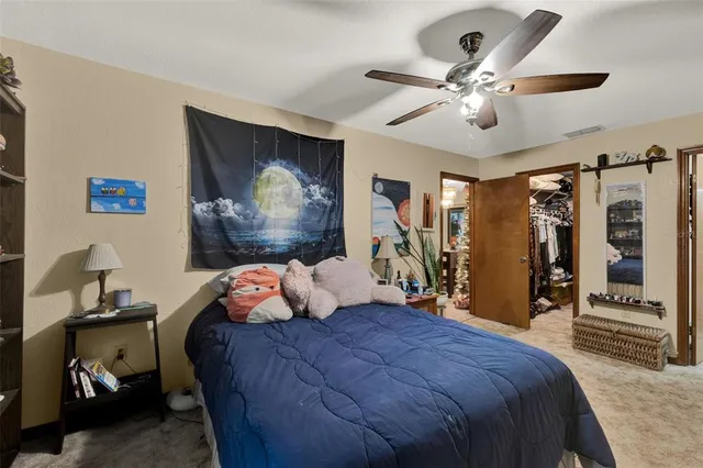 a bedroom with a bed and ceiling fan