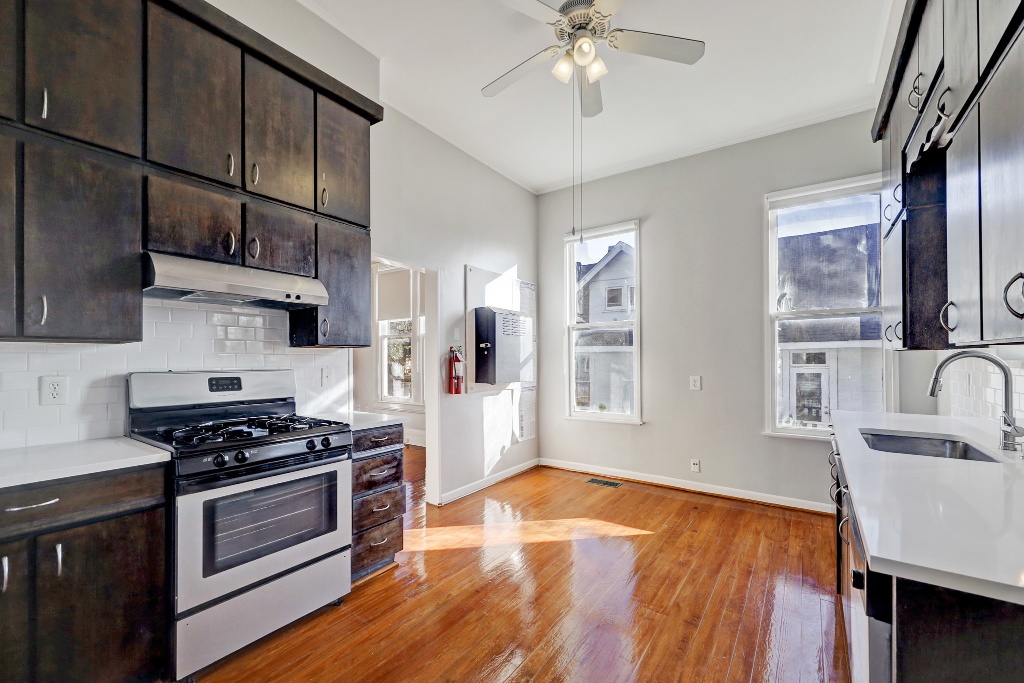 1229 Heights Boulevard Houston, TX 77008 - Photo 13 of 30 a kitchen with stainless steel appliances hardwood floor sink stove and wooden cabinets