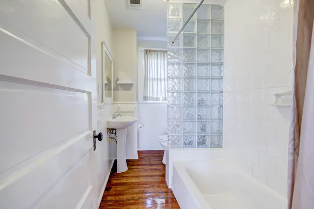 a bathroom with a bathtub and shower
