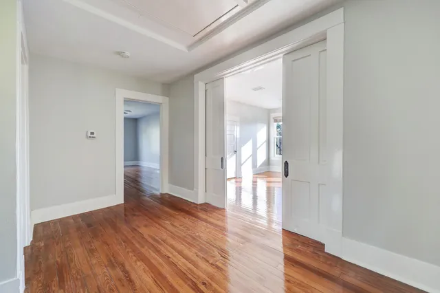 a view of empty room with wooden floor