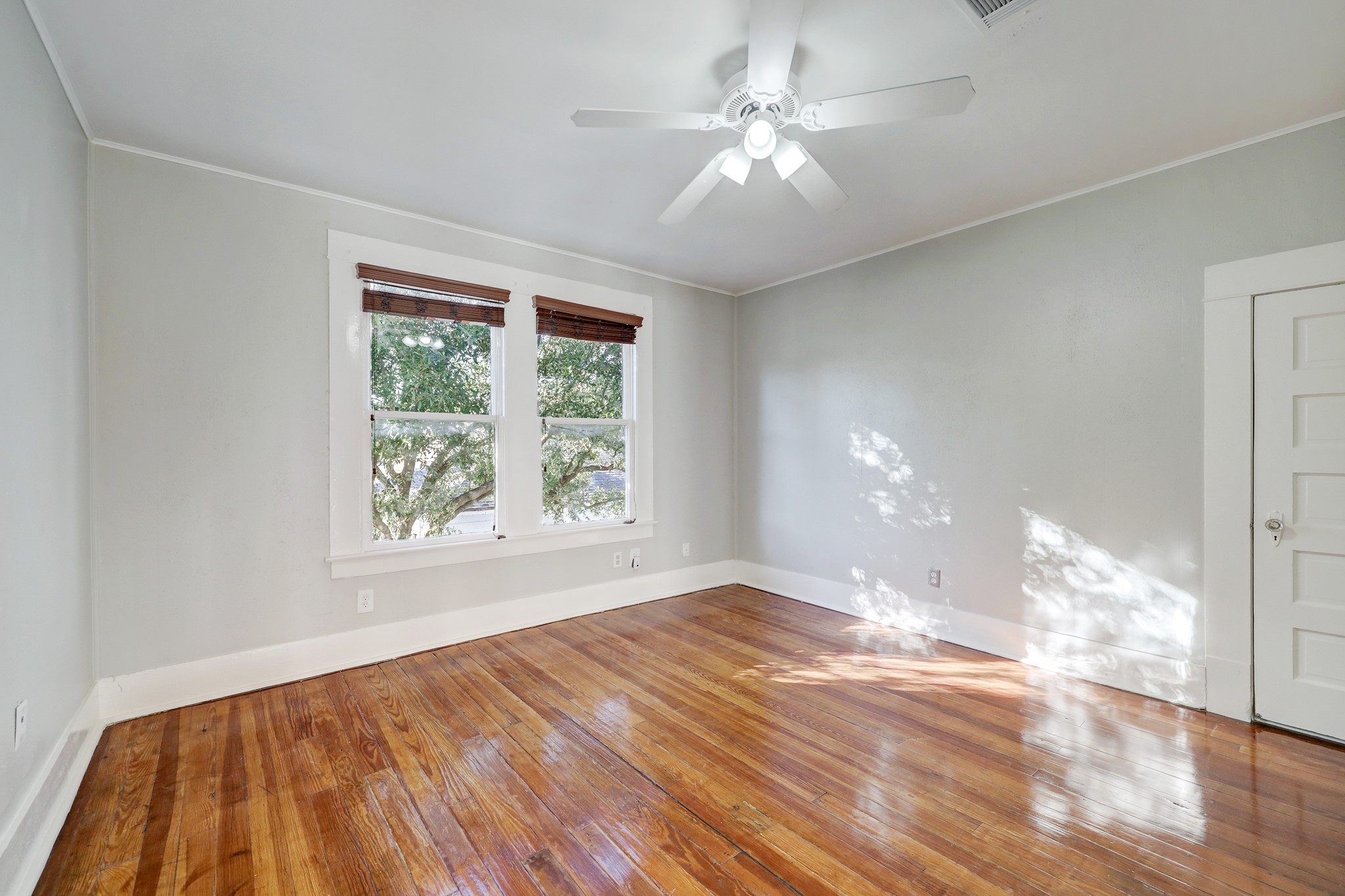 1229 Heights Boulevard Houston, TX 77008 - Photo 20 of 30 a view of an empty room with wooden floor and a window