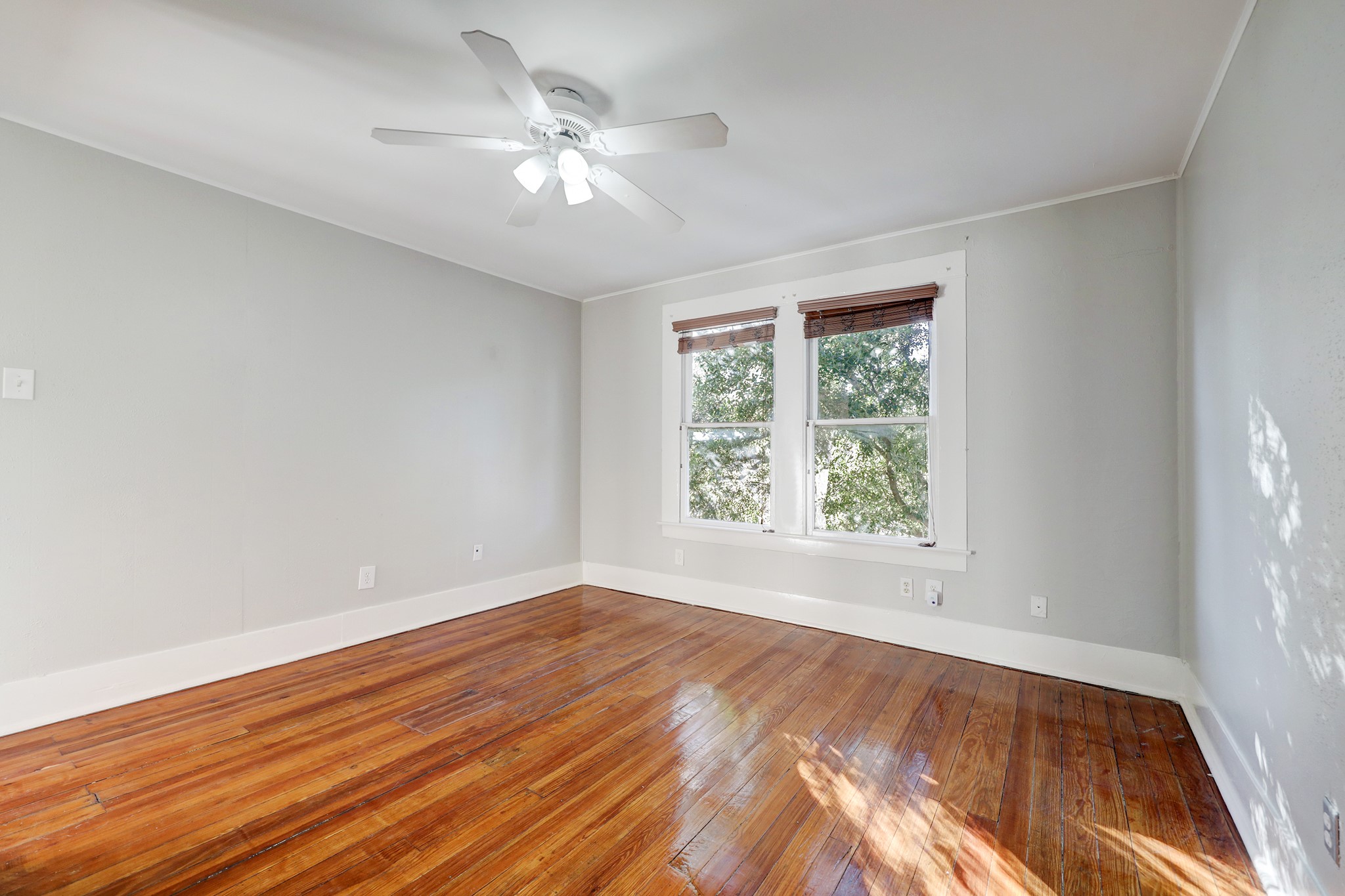 1229 Heights Boulevard Houston, TX 77008 - Photo 21 of 30 a view of an empty room with wooden floor and a window
