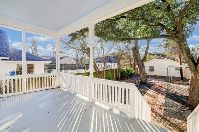 a view of a house with a wooden deck