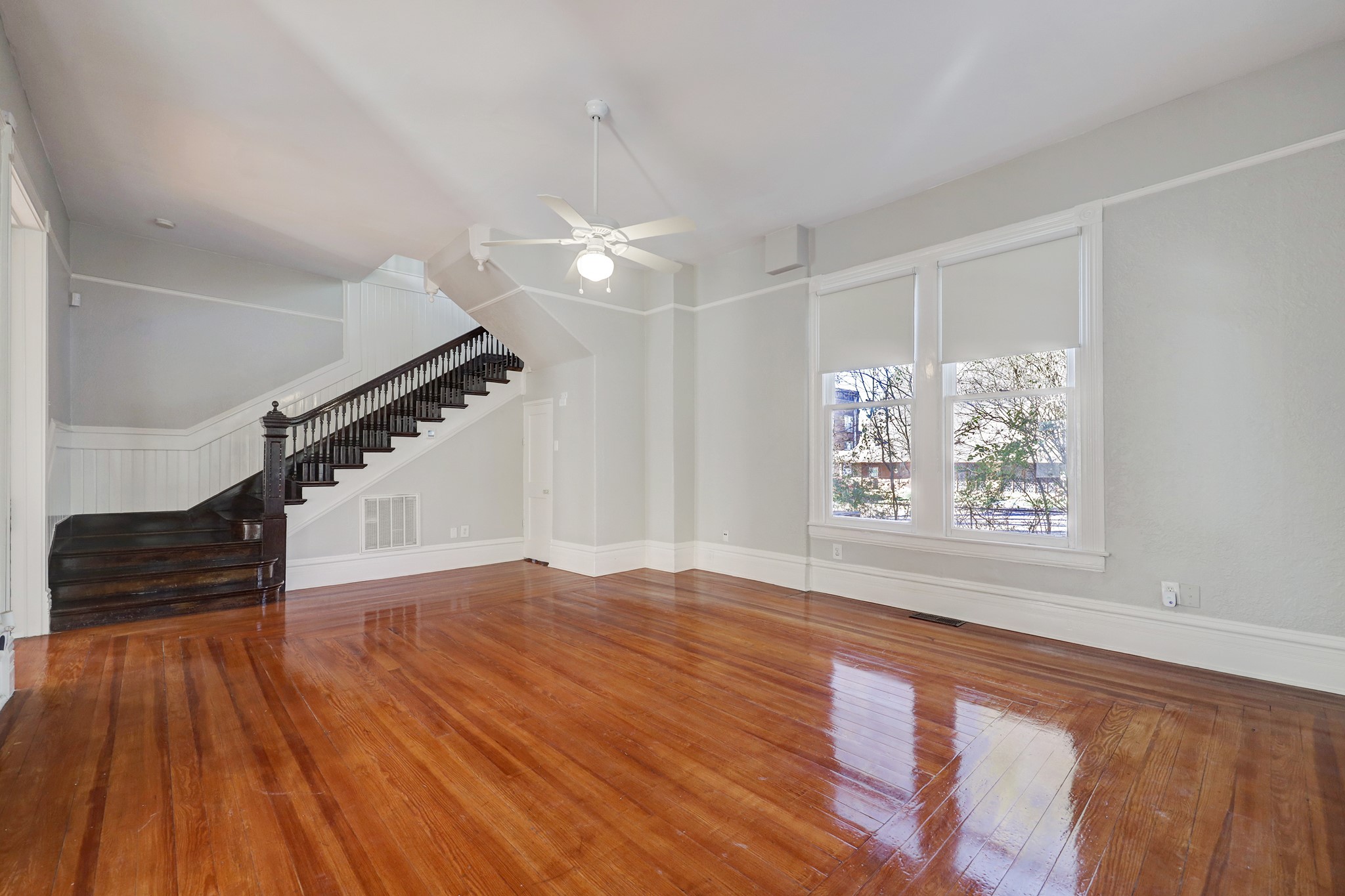 1229 Heights Boulevard Houston, TX 77008 - Photo 3 of 30 a view of an empty room with wooden floor and a window