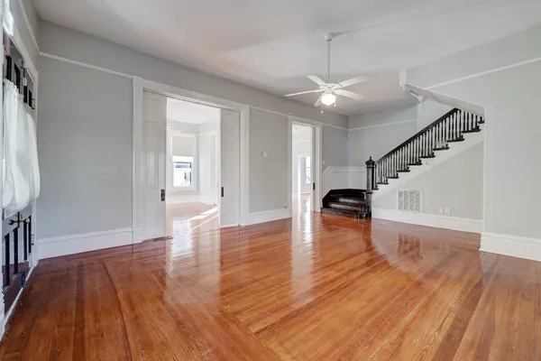 a view of empty room with wooden floor