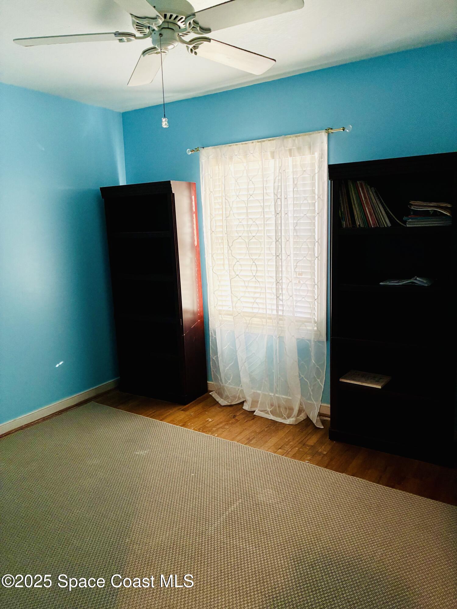 918 Jamestown Avenue, Unit 89 Indian Harbour Beach, FL 32937 - Photo 14 of 25 an empty room with a ceiling fan and a window