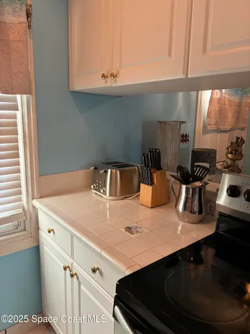 a kitchen with a sink dishwasher and a stove