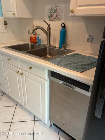 a kitchen with a sink a stove and cabinets