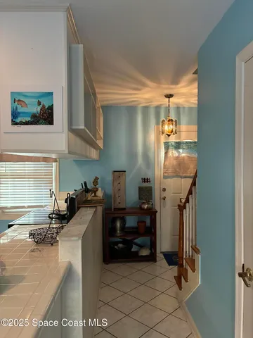 a kitchen with granite countertop a refrigerator and a stove top oven