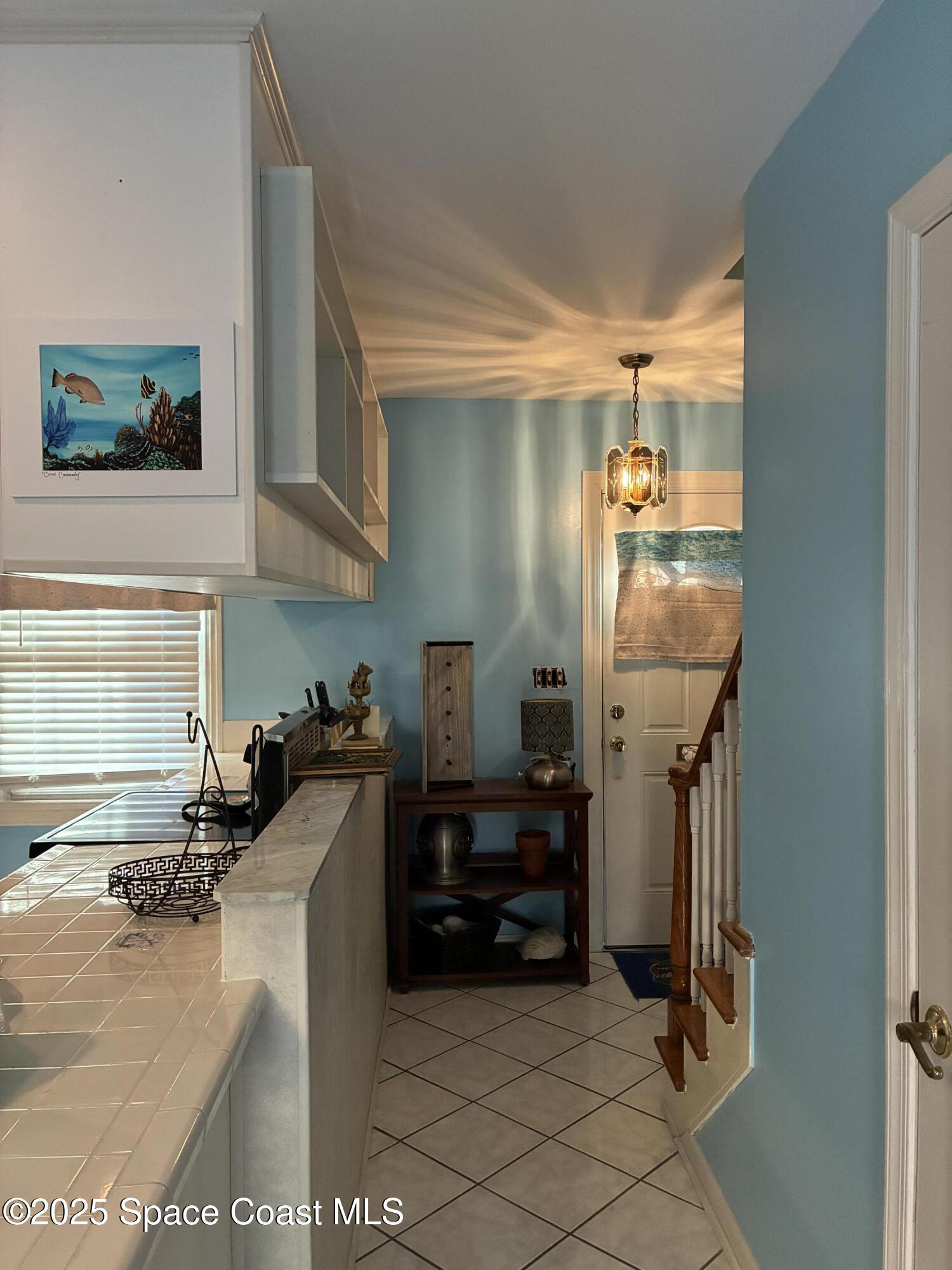 918 Jamestown Avenue, Unit 89 Indian Harbour Beach, FL 32937 - Photo 10 of 25 a kitchen with granite countertop a refrigerator and a stove top oven