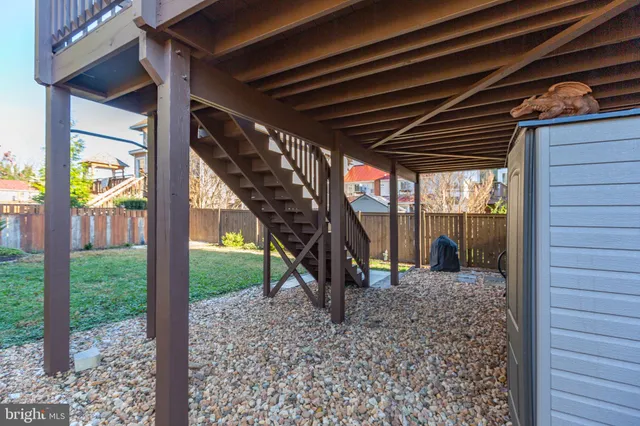 a view of a room with wooden stairs and a table