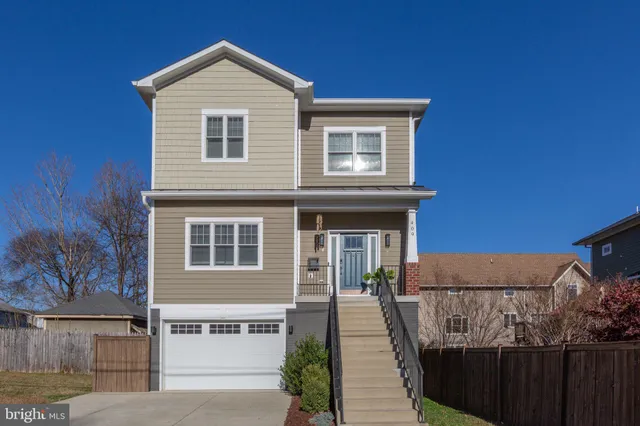 a view of a house with wooden fence and large windows