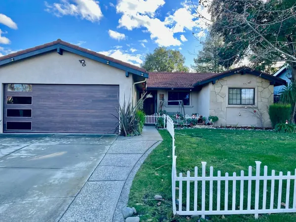 a front view of house with a garden