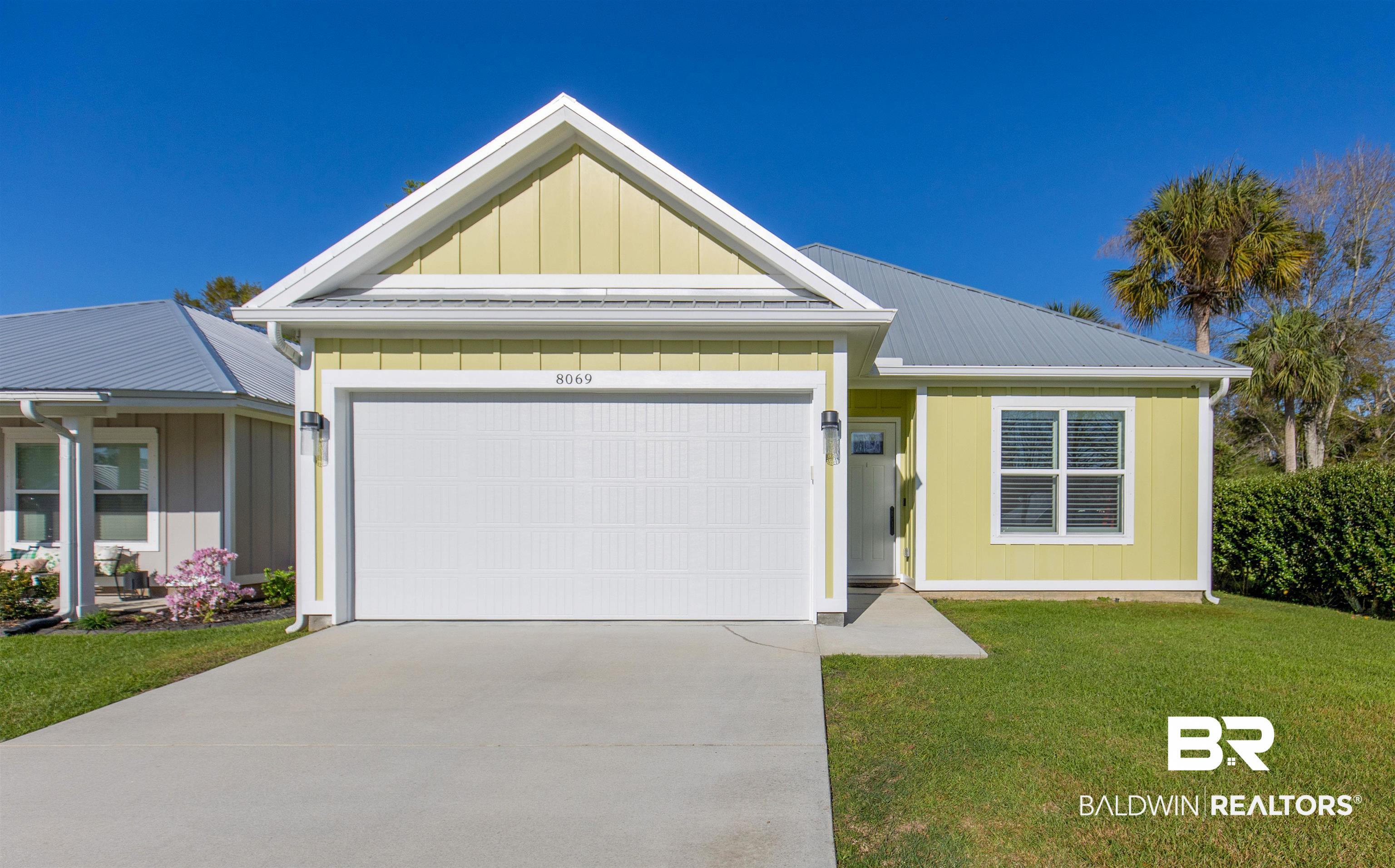 8069 Carmel Circle Foley, AL 36535 - Photo 2 of 23 View of front of house featuring driveway, an attached garage, board and batten siding, and a front yard
