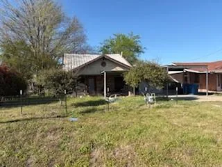 a view of house with a yard