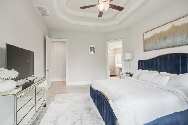 a spacious bathroom with a bathtub sink and mirror
