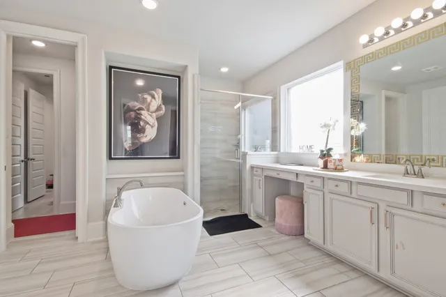 a spacious bathroom with a bathtub and a double vanity sink