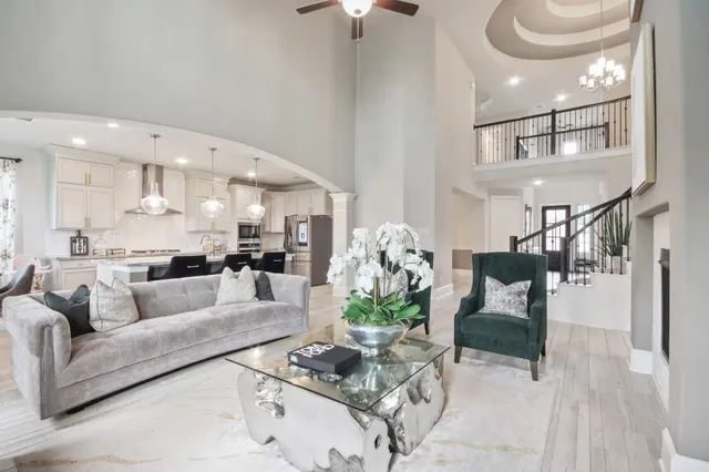 a kitchen with stainless steel appliances granite countertop a sink a stove and a wooden cabinets